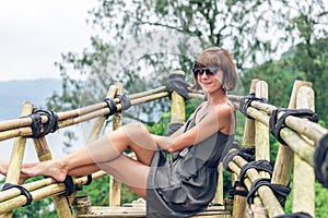 Close-up of beautiful girl posing in tropical forest of magic island Bali, Indonesia.