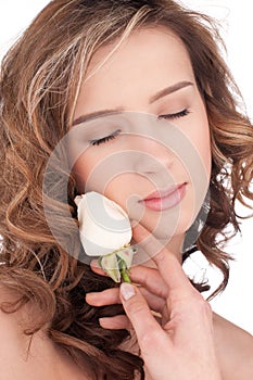 Close-up of beautiful girl with white rose flower