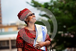 Close up of a beautiful mature african woman in traditional clothes, happy