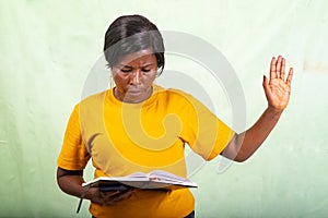 close up of beautiful mature woman looking at diary and making stop gesture