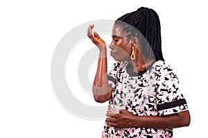 Close-up of a beautiful mature woman smelling perfume on her arm