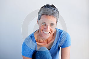 Close up beautiful mature woman smiling against white background