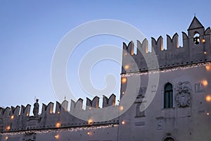Close up of beautiful medieval building in koper with christmas lights, slovenia