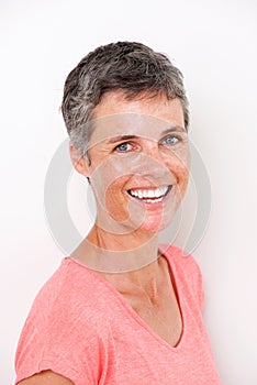 Close up beautiful middle age woman smiling by white wall