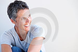 Close up beautiful older woman smiling against white background