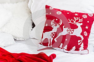 Close-up: Beautiful red Christmas pillow and blanked. Concept: lazy happy winter holiday at home