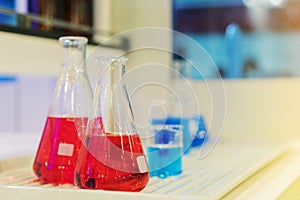 Close up of beautiful red colorful chemistry liquid in various laboratory flask for science