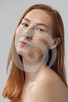 Close-up beautiful redheaded woman in lingerie posing isolated over gray studio back ground. Fitness, diet, sports