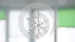 Close up of beautiful round snowflake hanging in home interior.