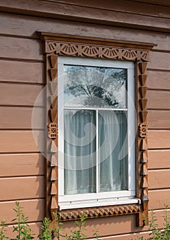 Close-up of a beautiful window with carved platbands.