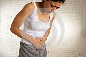 Close up of beautiful woman body suffering from stomachache, period pain and menstrual cramps