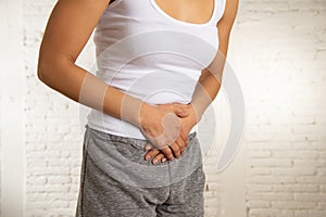 Close up of beautiful woman body suffering from stomachache, period pain and menstrual cramps photo