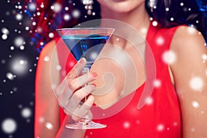 Close up of beautiful woman with cocktail at night