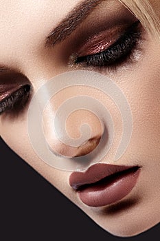 Close-up of Beautiful Woman Face. Fashion Evening Make-up, Glitter Eyeshadows, Matt Lips, Shiny Clean Skin. Sexy Style photo