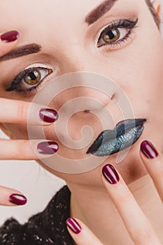 Close up of beautiful woman face portrait with tinsel makeup