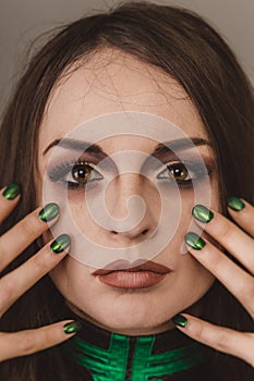 Close up of beautiful woman face portrait with tinsel makeup