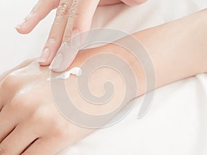 Close up beautiful woman hands with cream