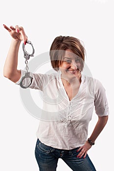 Close up of a beautiful woman smiling and showing handcuffs