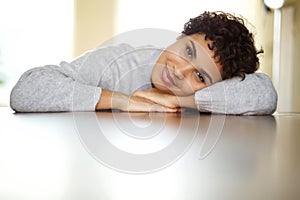 Close up beautiful young african american woman leaning on table and looking at camera