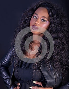 Close-up of beautiful young African model with curly long hair and red full lips