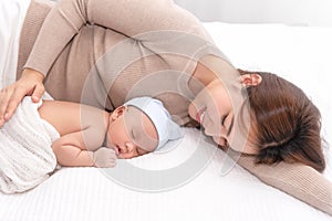 Close up beautiful young asian mother laying down smiling with son. Healthcare and medical love asia woman lifestyle mother`s day