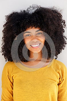 Close up beautiful young black woman with curly hair against white background