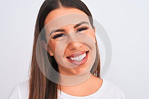 Close up of beautiful and young brunette woman standing over isolated white background with a happy face standing and smiling with