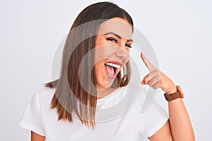 Close up of beautiful and young brunette woman standing over isolated white background very happy pointing with hand and finger