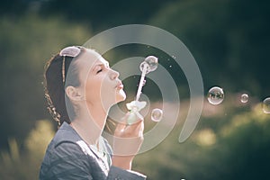 Close up. beautiful young woman blowing bubbles