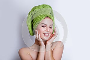 Close-up of beautiful young woman with green bath towel