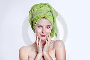 Close-up of beautiful young woman with green bath towel
