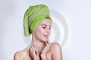 Close-up of beautiful young woman with green bath towel