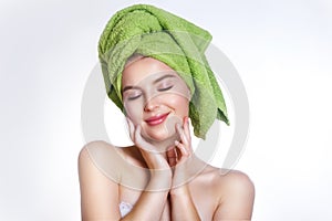 Close-up of beautiful young woman with green bath towel