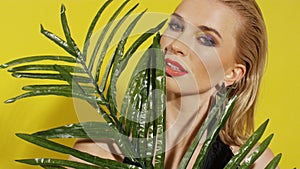 Close up of beautiful young woman posing over yellow background.