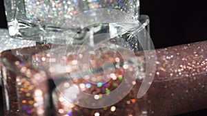 Close-up beauty. Bottles nail polish rotates on a black background