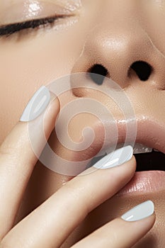 Close-up beauty. Model face with light make-up & manicure