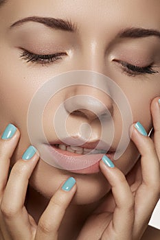 Close-up beauty. Model face with natural make-up & bright manicure