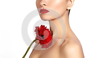 Close-up beauty photo woman with red lips, lipstick and beautiful red flower. Spa clean skin