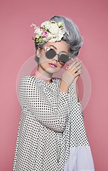 Close up beauty portrait in barocco style in polka-dot dress. Fashion bright pink studio background photo