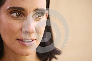 Close Up Beauty Portrait Of Smiling Mature Woman Against Natural Background