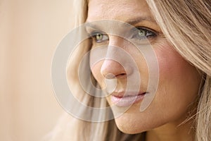 Close Up Beauty Portrait Of Smiling Mature Woman Against Natural Background