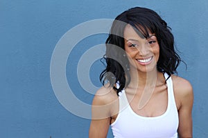 Close up beauty portrait of a young and attractive African American black woman with perfect skin, softly smiling