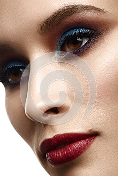 Close-up beauty portrait of young pretty woman with bright evening make-up .