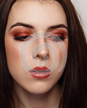 Close-up beauty portrait of young woman with beautiful bright makeup. Modern smokey eyes with colorful eyeshadows