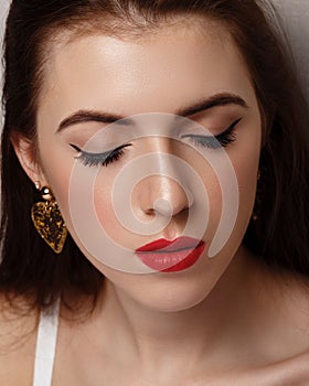 Close-up beauty portrait of young woman with beautiful bright makeup. Modern smokey eyes with colorful eyeshadows