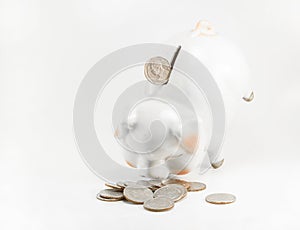 Close up beautyful piggy bank and coins on white background for financial and saving artwork with copyspace photo