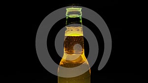 Close-Up Of A Beer Bottle Where The Bubbles Rise