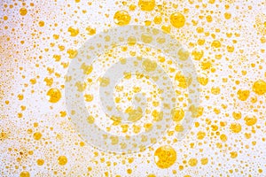 Close up of beer bubbles and foam as a background. Oktoberfest abstract background. Craft lager beer. Festive pint of ale with