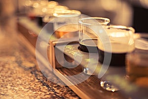 Close up of beer flights on granite bar top with selective focus