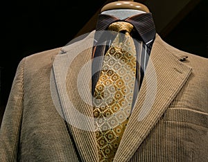 Beige Corduroy Jacket With Black Striped Shirt and Yellow Tie photo